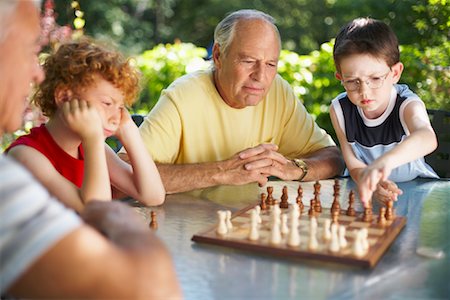 simsearch:700-01234773,k - Men Playing Chess with their Grandsons Stock Photo - Premium Royalty-Free, Code: 600-01073548