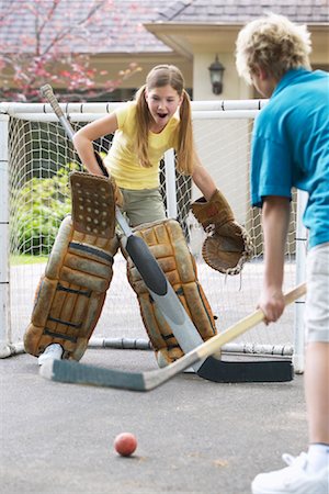 Children Playing Street Hockey Stock Photo - Premium Royalty-Free, Code: 600-01083058