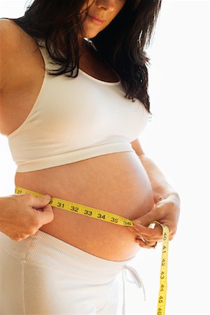 simsearch:700-00424715,k - Pregnant Woman Measuring Stomach Stock Photo - Premium Royalty-Free, Code: 600-01083449