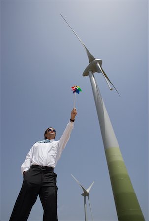 simsearch:600-01878939,k - Businessman with Pinwheel by Wind Turbine Foto de stock - Royalty Free Premium, Número: 600-01109969