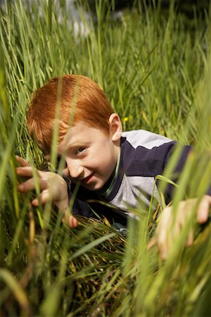 simsearch:600-01100083,k - Portrait of Boy Peeking through Long Grass Stock Photo - Premium Royalty-Free, Code: 600-01100014