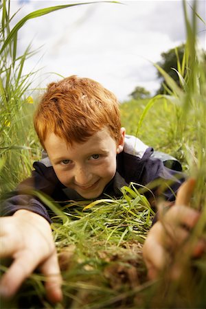 simsearch:600-01100083,k - Portrait of Boy Peeking through Long Grass Stock Photo - Premium Royalty-Free, Code: 600-01100016