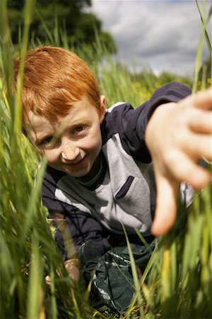 simsearch:600-01100083,k - Portrait of Boy Peeking through Long Grass Stock Photo - Premium Royalty-Free, Code: 600-01100012