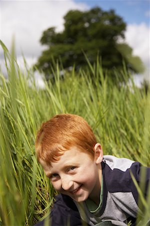 simsearch:600-01100083,k - Portrait of Boy Peeking through Long Grass Stock Photo - Premium Royalty-Free, Code: 600-01100013