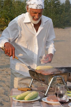 Man Barbecuing on Beach Stock Photo - Premium Royalty-Free, Code: 600-01119937