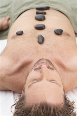 simsearch:600-01110360,k - Man Getting Warming Rock Therapy Stock Photo - Premium Royalty-Free, Code: 600-01110382