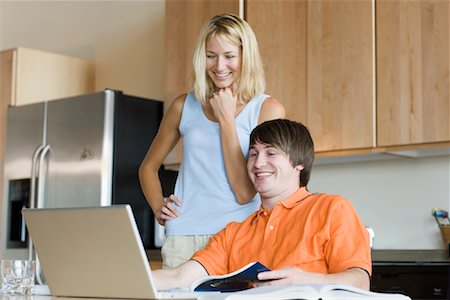 simsearch:700-00688680,k - Couple in Kitchen with Laptop Computer Stock Photo - Premium Royalty-Free, Code: 600-01111621