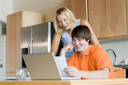 simsearch:700-00609233,k - Couple in Kitchen with Laptop Computer Stock Photo - Premium Royalty-Free, Code: 600-01111623