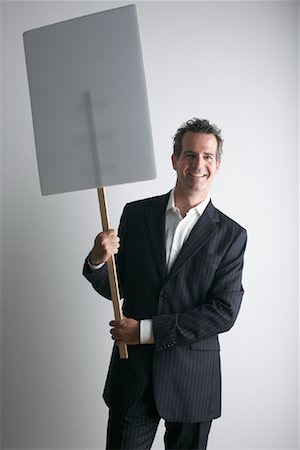 Businessman Holding Sign Foto de stock - Sin royalties Premium, Código: 600-01112002