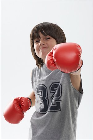 Portrait of Boy Wearing Boxing Gloves Foto de stock - Sin royalties Premium, Código: 600-01112023