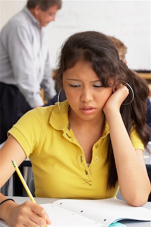 female teacher writing on whiteboard - Student Writing in Notebook Stock Photo - Premium Royalty-Free, Code: 600-01112320