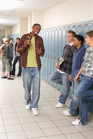 Boy Showing off Trophy in High School Hallway Stock Photo - Premium Royalty-Free, Code: 600-01112339