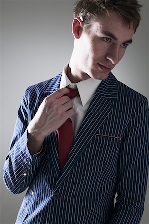 Young Man Loosening Tie Stock Photo - Premium Royalty-Free, Code: 600-01112856