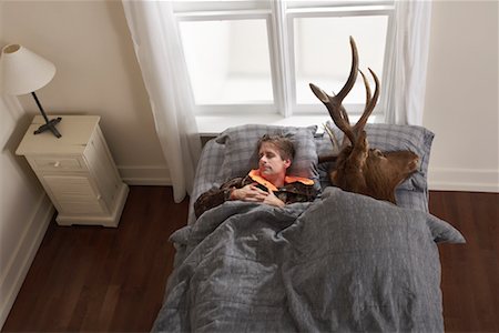 simsearch:600-01124353,k - Hunter Sleeping with Deer Head Stock Photo - Premium Royalty-Free, Code: 600-01124360