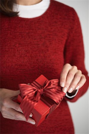 simsearch:600-02046034,k - Woman Adjusting Bow on Gift Stock Photo - Premium Royalty-Free, Code: 600-01124647