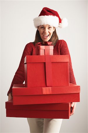 simsearch:600-00847728,k - Woman in Santa Hat Carrying Gifts Stock Photo - Premium Royalty-Free, Code: 600-01124640