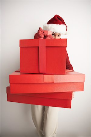 simsearch:649-08085108,k - Woman in Santa Hat Carrying Gifts Stock Photo - Premium Royalty-Free, Code: 600-01124641
