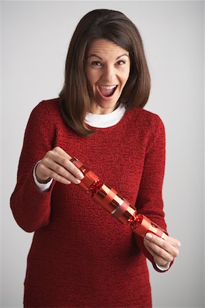 simsearch:600-00847728,k - Woman Holding Christmas Cracker Stock Photo - Premium Royalty-Free, Code: 600-01124650