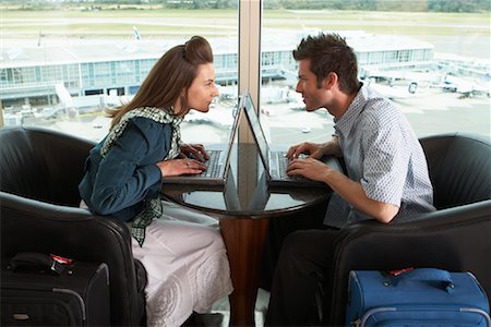 Couple Using Laptops in Airport, Vancouver, British Columbia, Canada Stock Photo - Premium Royalty-Free, Code: 600-01124844