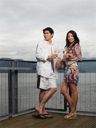 fashion style dress shoes men - Couple Standing on Deck by Ocean Drinking Wine Stock Photo - Premium Royalty-Free, Code: 600-01124842