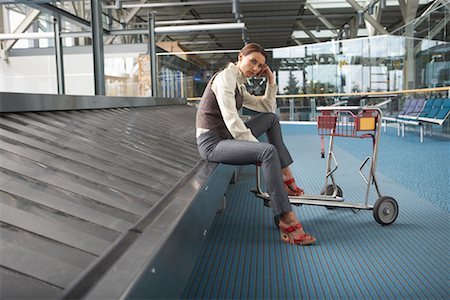 Woman Waiting for Luggage, Vancouver, British Columbia, Canada Stock Photo - Premium Royalty-Free, Code: 600-01124873