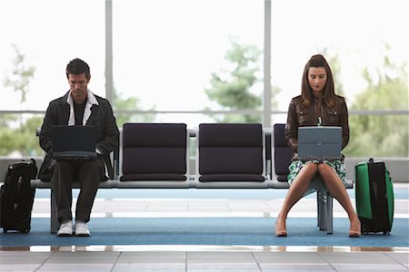 Man and Woman in Airport Waiting Area Stock Photo - Premium Royalty-Free, Code: 600-01124904