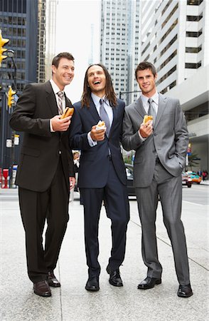 Businessmen Eating Hot Dogs Stock Photo - Premium Royalty-Free, Code: 600-01120099