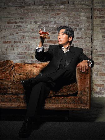 disco style man - Portrait of Man on Sofa with Glass of Liquor Stock Photo - Premium Royalty-Free, Code: 600-01123795