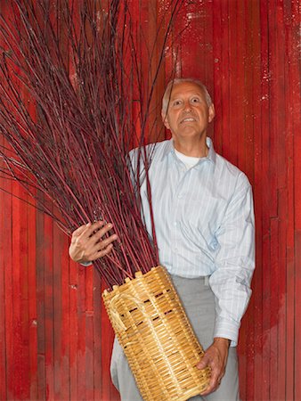 Man Holding Basket of Branches Stock Photo - Premium Royalty-Free, Code: 600-01123808