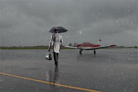 servicing a plane - Backview of Businessman Walking on Tarmac in Rainy Weather Stock Photo - Premium Royalty-Free, Code: 600-01174006