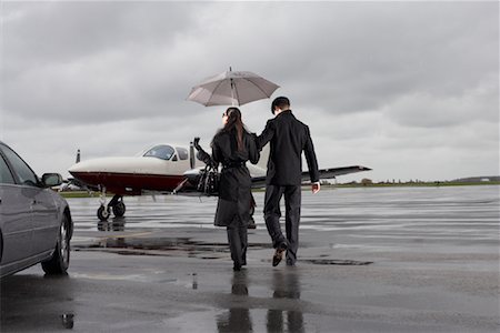 Man and Woman on Airport Tarmac Stock Photo - Premium Royalty-Free, Code: 600-01174017