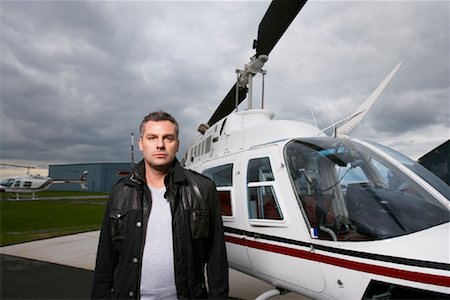 Portrait of Man Beside Helicopter Stock Photo - Premium Royalty-Free, Code: 600-01174074