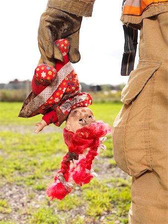 Firefighter Carrying Doll Stock Photo - Premium Royalty-Free, Code: 600-01172241