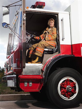 photo of woman driving a truck - Firefighter in Fire Truck Stock Photo - Premium Royalty-Free, Code: 600-01172252