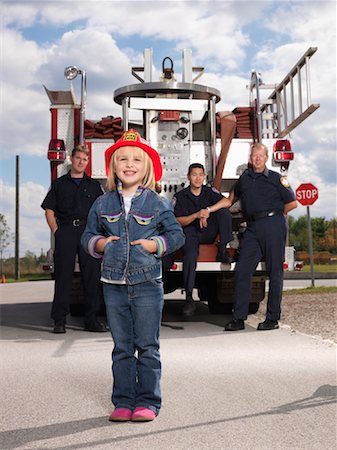 Portrait of Girl with Fire Fighters Stock Photo - Premium Royalty-Free, Code: 600-01172282