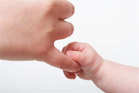 Baby's Hand Holding Adult's Finger Stock Photo - Premium Royalty-Free, Code: 600-01172761