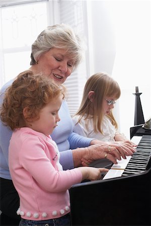 Woman Playing Piano with Granddaughters Stock Photo - Premium Royalty-Free, Code: 600-01182906