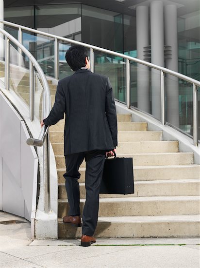 1 person stairs back of people business going up BUSINESS MAN WALKING 