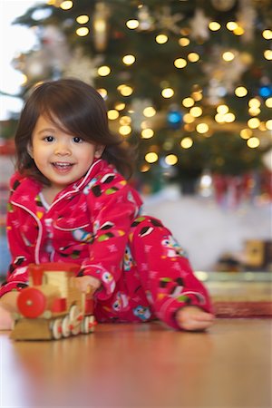 Little Girl Playing with Toy Train on Christmas Morning Stock Photo - Premium Royalty-Free, Code: 600-01195005