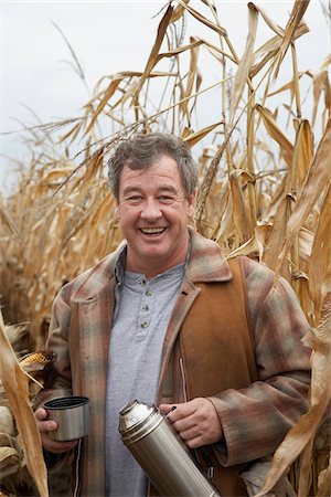 Farmer in Cornfield with Thermos Stock Photo - Premium Royalty-Free, Code: 600-01196533