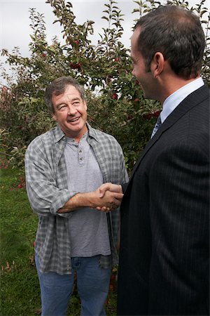 Businessman and Farmer in Orchard Stock Photo - Premium Royalty-Free, Code: 600-01196542