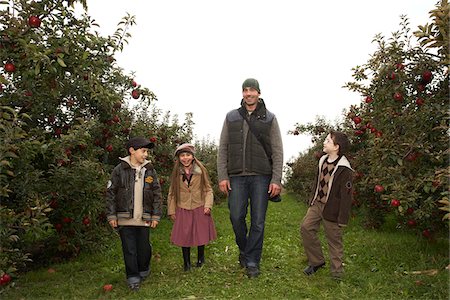Man Walking in Orchard with Children Stock Photo - Premium Royalty-Free, Code: 600-01196562