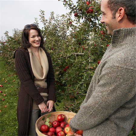 Couple in Apple Orchard Stock Photo - Premium Royalty-Free, Code: 600-01196594