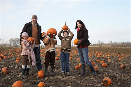 Portrait of Family in Pumpkin Patch Stock Photo - Premium Royalty-Free, Code: 600-01196599