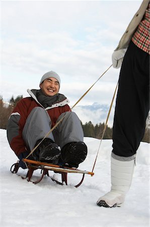 simsearch:600-01224168,k - Woman Pulling Man on Sled, Whistler, British Columbia, Canada Stock Photo - Premium Royalty-Free, Code: 600-01224152