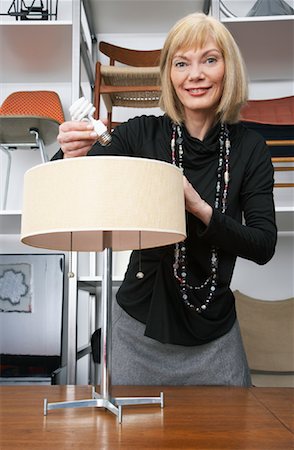 simsearch:600-01224439,k - Portrait of Woman Putting Lightbulb in Furniture Store Stock Photo - Premium Royalty-Free, Code: 600-01224462