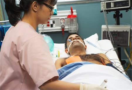 patient oxygen breathing - Nurse Tending to Patient Stock Photo - Premium Royalty-Free, Code: 600-01223663