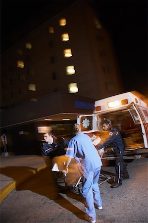 simsearch:400-05343071,k - Doctor and Paramedics Removing Patient from Ambulance Stock Photo - Premium Royalty-Free, Code: 600-01235372