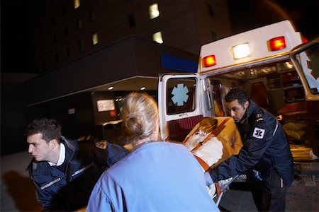 simsearch:400-05343071,k - Doctor and Paramedics Removing Patient from Ambulance Stock Photo - Premium Royalty-Free, Code: 600-01235373