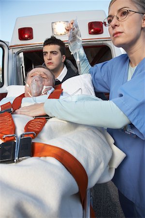 simsearch:400-05343071,k - Paramedic and Doctor with Patient on Stretcher Stock Photo - Premium Royalty-Free, Code: 600-01235386